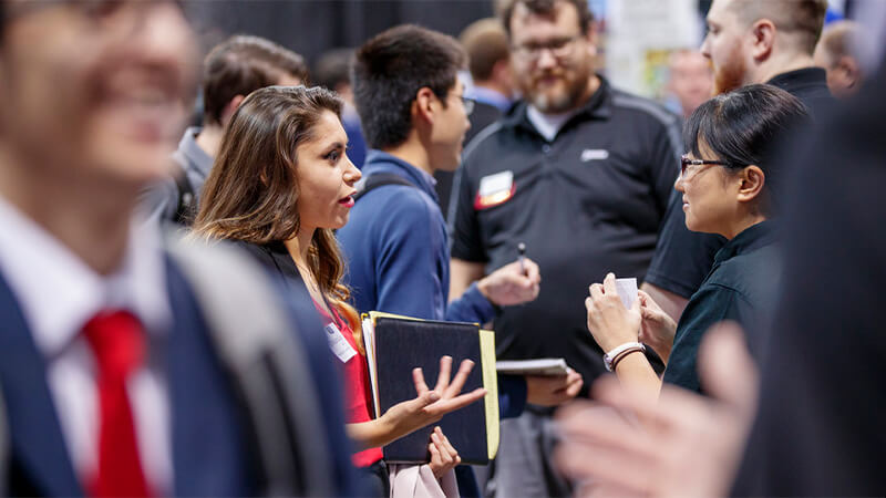 Students interact at a UNL career fair.