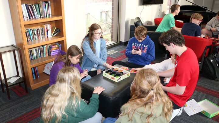 Shirley and other students playing a board game